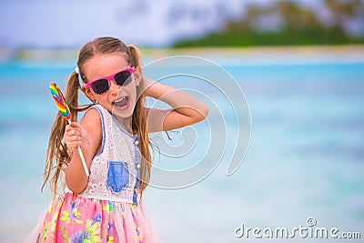 Adorable little girl have fun with lollipop on the Stock Photo