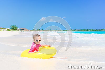 Adorable little girl with inflatable rubber circle splashing. Kid having fun on summer active vacation Stock Photo