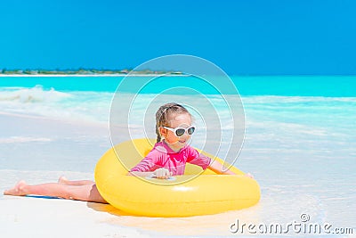 Adorable little girl with inflatable rubber circle splashing. Kid having fun on summer active vacation Stock Photo