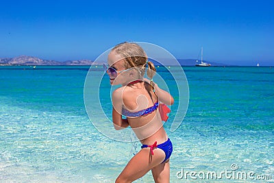 Adorable little girl playing with toy on beach Stock Photo