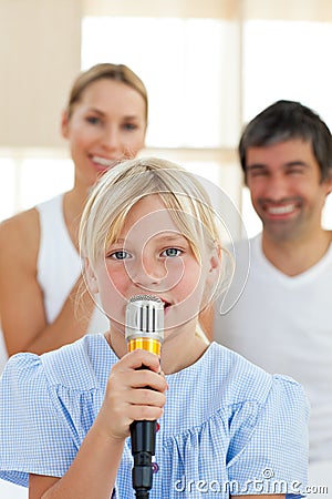 Adorable little girl singing with a microphone Stock Photo