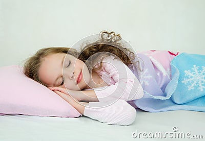 Adorable little girl sleeping in her bed Stock Photo