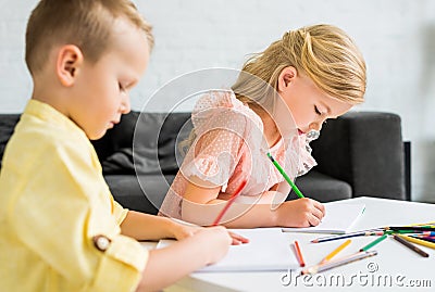 adorable little kids drawing with colored pencils Stock Photo