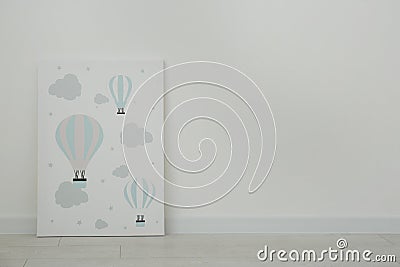 Adorable picture of air balloons on floor near wall, space for text. Children`s room interior element Stock Photo