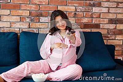 Adorable pregnant female enjoy watching tv at home Stock Photo