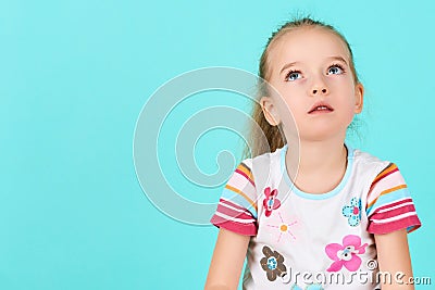 Adorable preschooler girl deep in thoughts, looking up. Concentration, decision, vision concept. Stock Photo