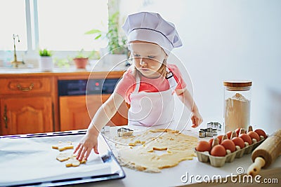 Adorable preschooler girl making cookies Stock Photo