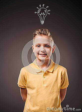 adorable preteen smiling boy with drawn light bulb idea, Stock Photo