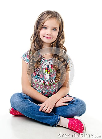 Adorable smiling little girl sitting on a floor Stock Photo