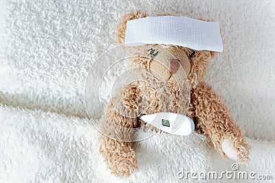 Ill teddy bear with plaster. Stock Photo