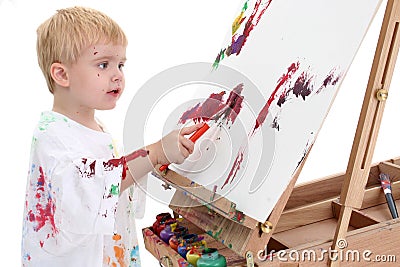 Adorable Toddler Boy Painting at Easel Stock Photo