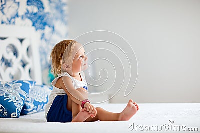 Adorable toddler girl in bedroom Stock Photo
