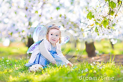 Adorable toddler girl in fairy costume in fruit garden Stock Photo