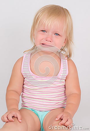 Adorable unsatisfied girl sit and cry Stock Photo