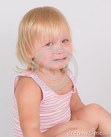 Adorable unsatisfied girl sit and cry on white Stock Photo