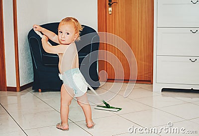 Adorable 1 year old baby boy helping with cleaning Stock Photo