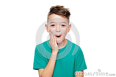 Adorable young boy in shock, isolated over white background. Shocked child looking at camera in disbelief. Shock, amazement. Stock Photo