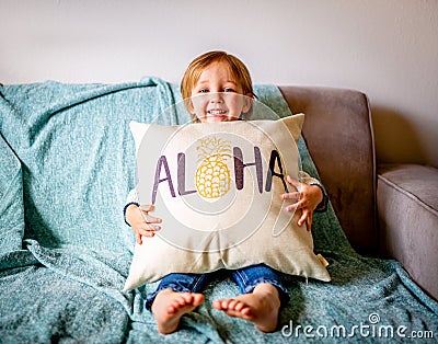 Young Boy Sits on Couch Stock Photo