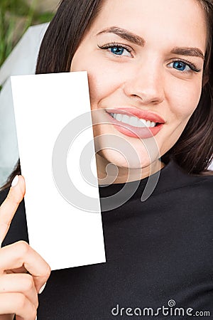 Adorable young woman holding box with empty space you can place you text or logo. Cosmetics industry. Close up portrait Stock Photo