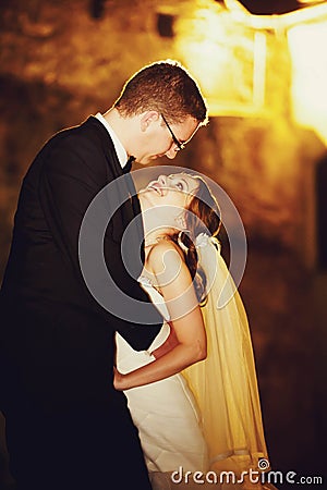 Adorning elegant fashion groom and bride is hugging on the back Stock Photo
