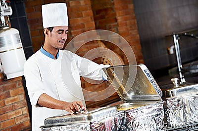 Arab chef with food at restaurant hotel Stock Photo