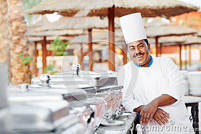 Arab chef with food at restaurant hotel Stock Photo