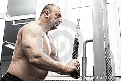 The adult brutal man is engaged in power bodybuilding Stock Photo