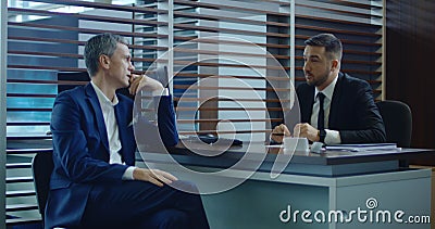 Conversation of businessman and sales manager in showroom Stock Photo