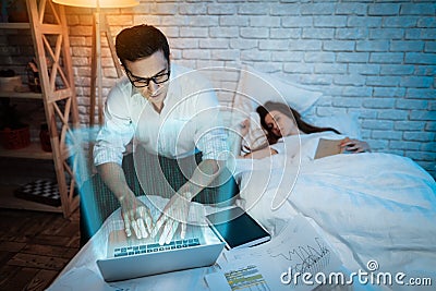 Adult businessman works at night at home. Successful trader analyzing charts of currency pairs. Stock Photo