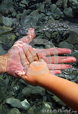 Adult and children hands holding underwater Stock Photo