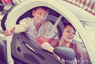 Adult couple sitting in twizy electric Stock Photo