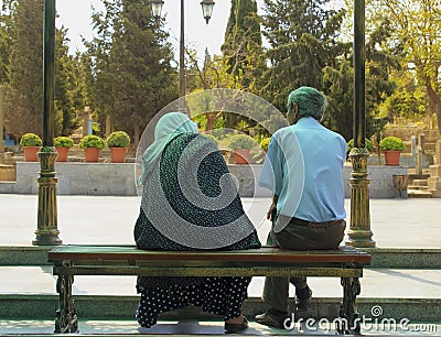 Adult couple in sorrow on the bench sitting back Editorial Stock Photo