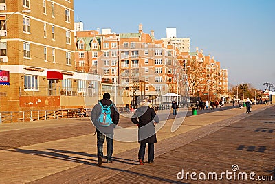An adult couple walks along the boardwalk on a winter`s day Editorial Stock Photo