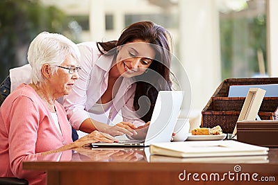 Adult Daughter Helping Mother With Laptop Stock Photo