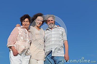 Adult daughter and her parents embracing Stock Photo
