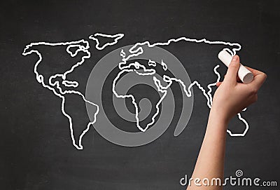 Adult drawing world map on chalkboard Stock Photo