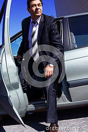 Adult, elderly, solid, a man gets out of the car Stock Photo