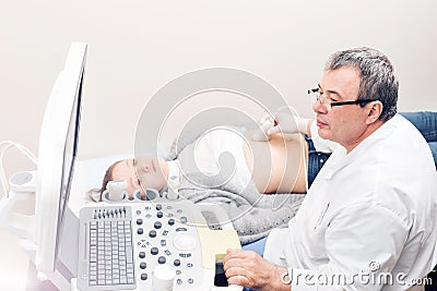 Adult female patient going through abdomen ultrasound at private clinic. Stock Photo