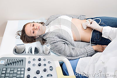 Adult female patient going through abdomen ultrasound at private clinic. Stock Photo