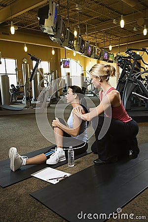 Adult female with personal trainer. Stock Photo