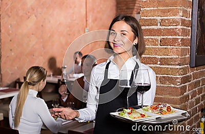 Adult female waiter showing country restaurant Stock Photo