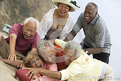 Adult Friends Playing American Football Stock Photo