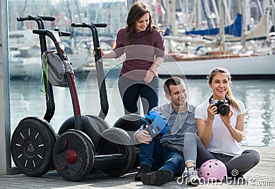 Adult friends with segways near sea Stock Photo