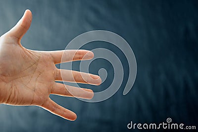 Adult hand with Raynaud`s Syndrome - Phenomenon. Close up hand with fingers on dark background with copy space Stock Photo