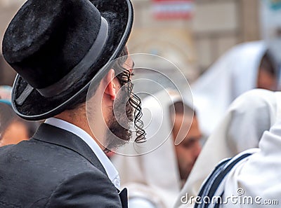 An adult Hasid in a traditional hat and with long payos. Prayer of Hasidim Editorial Stock Photo