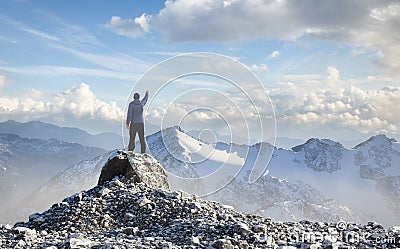 Adult Hiker Male standing on top of a rocky mountain Stock Photo