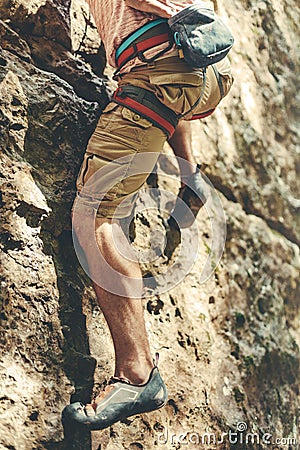 Adult Male Mountaineer In Safety Harness Climbs A Rock Wall. Extreme Hobby Outdoor Activity Concept Stock Photo