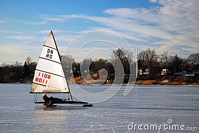 An adult man glides across a frozen river on his ice yacht Editorial Stock Photo