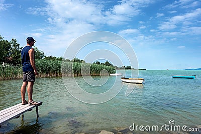 Adult man looks at Balaton Lake in the summer Stock Photo