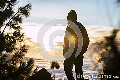 Adult man standing and looking the sunset enjoying freedom and healthy lifestyle outdoor - nature and travel people with sunlight Stock Photo